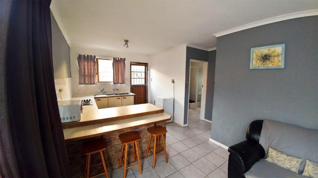 Open-plan kitchenette and seating area at Blouberg Beach Retreat